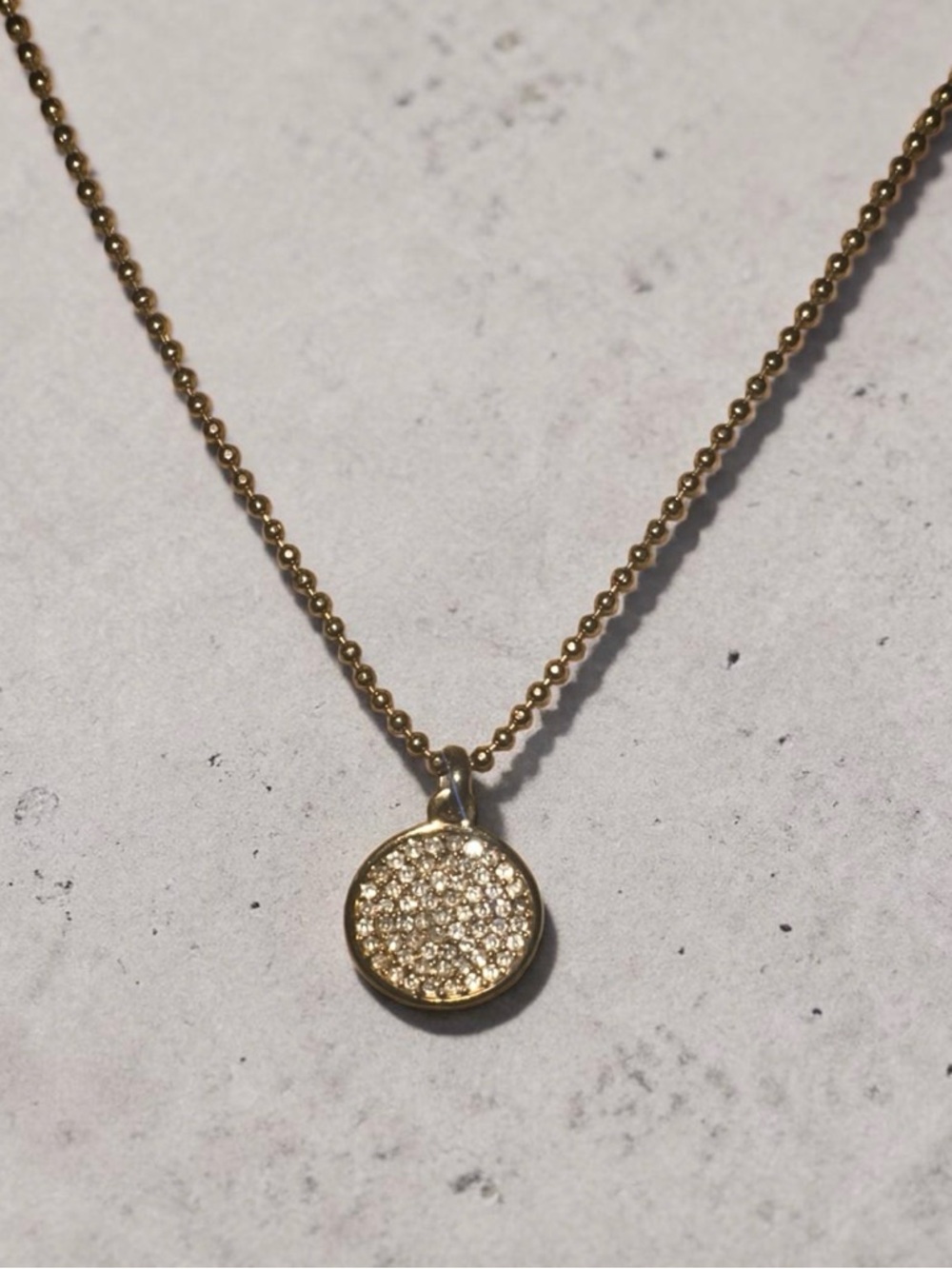 Michael Kors Gold Tone crystal disc toggle Circle Pendant Necklace